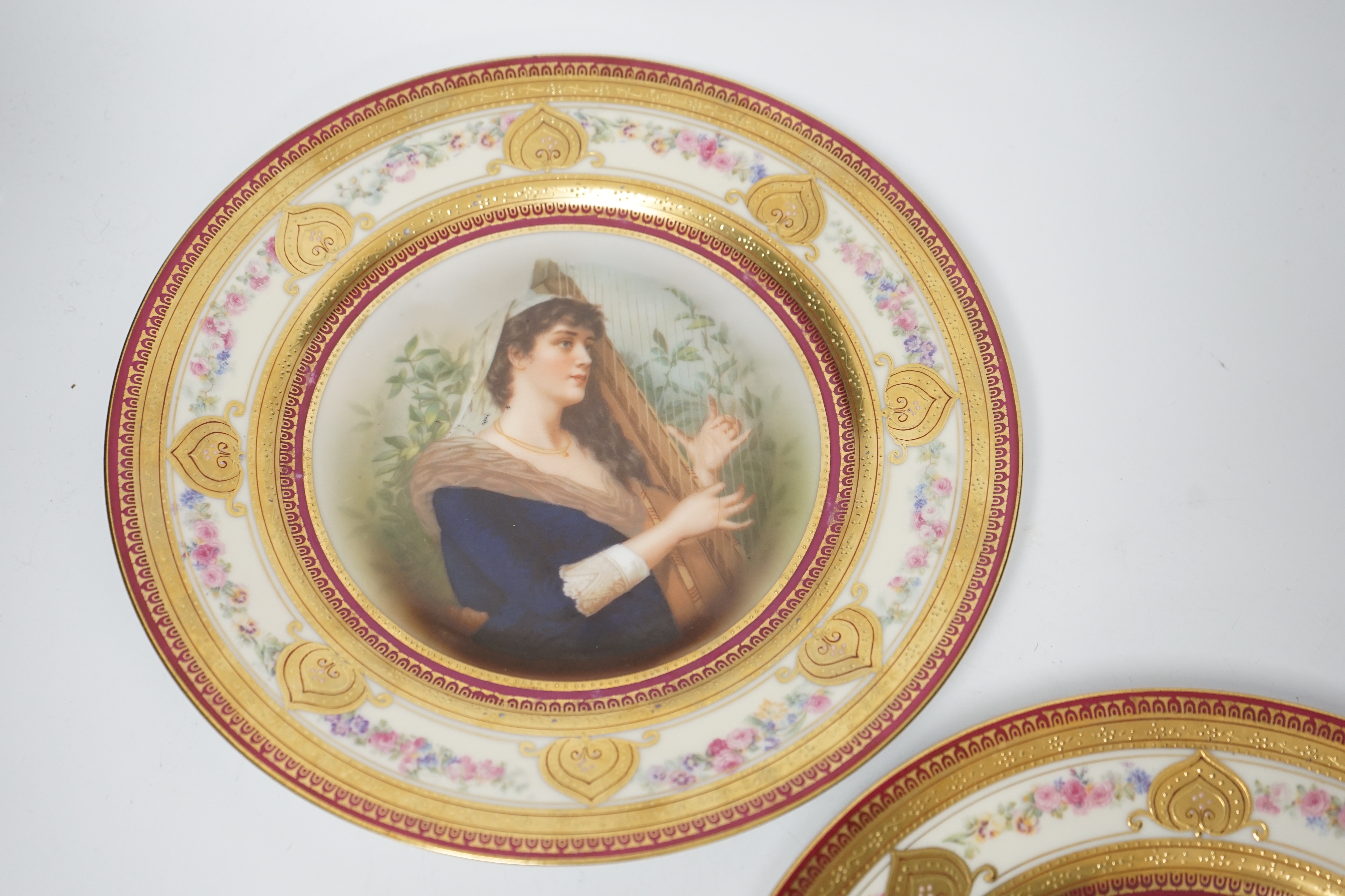 A pair of early 20th century Schwarzburg cabinet plates, a mason and a harpist, 26cm